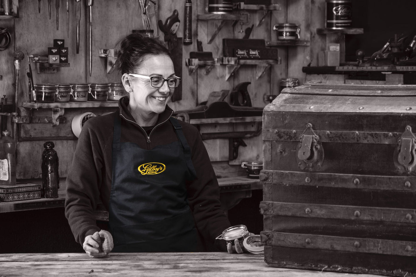 Jo wearing the restorer's bib apron in the workshop