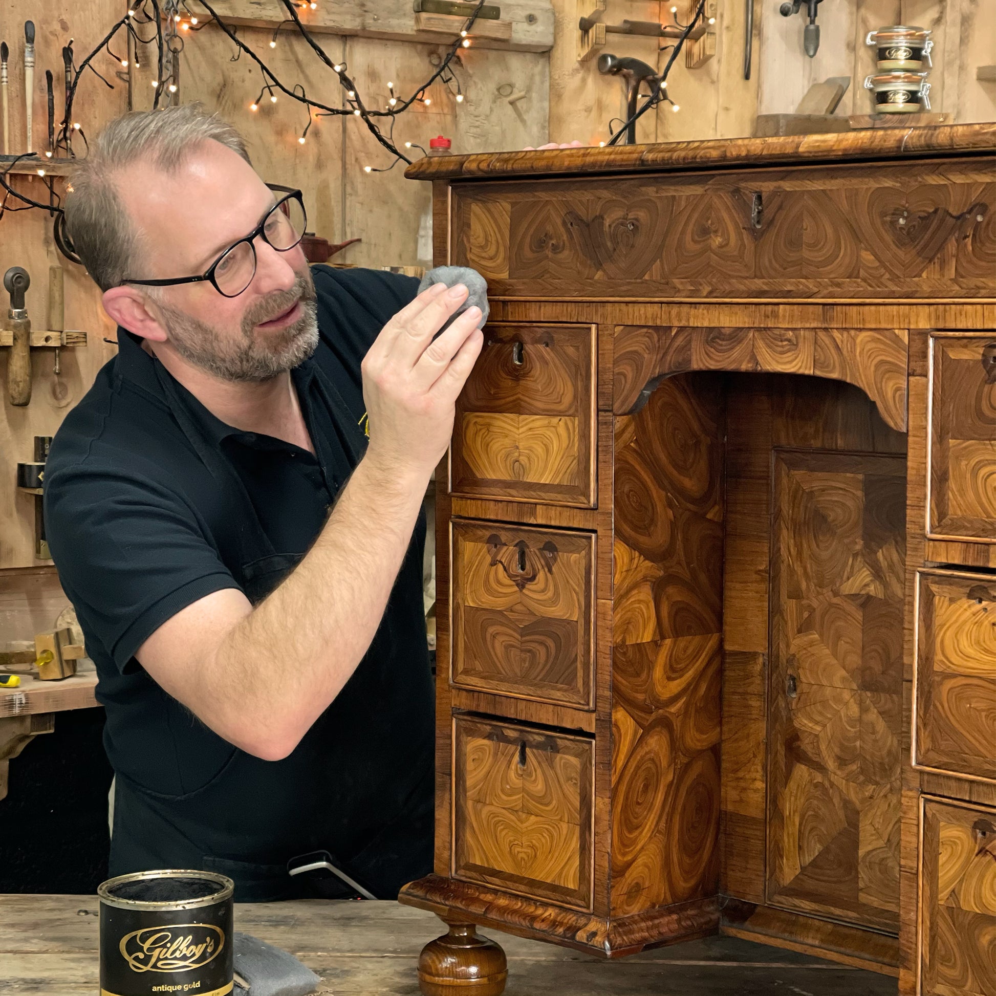 Wax polishing early 18th Century Oyster Veneered desk 
