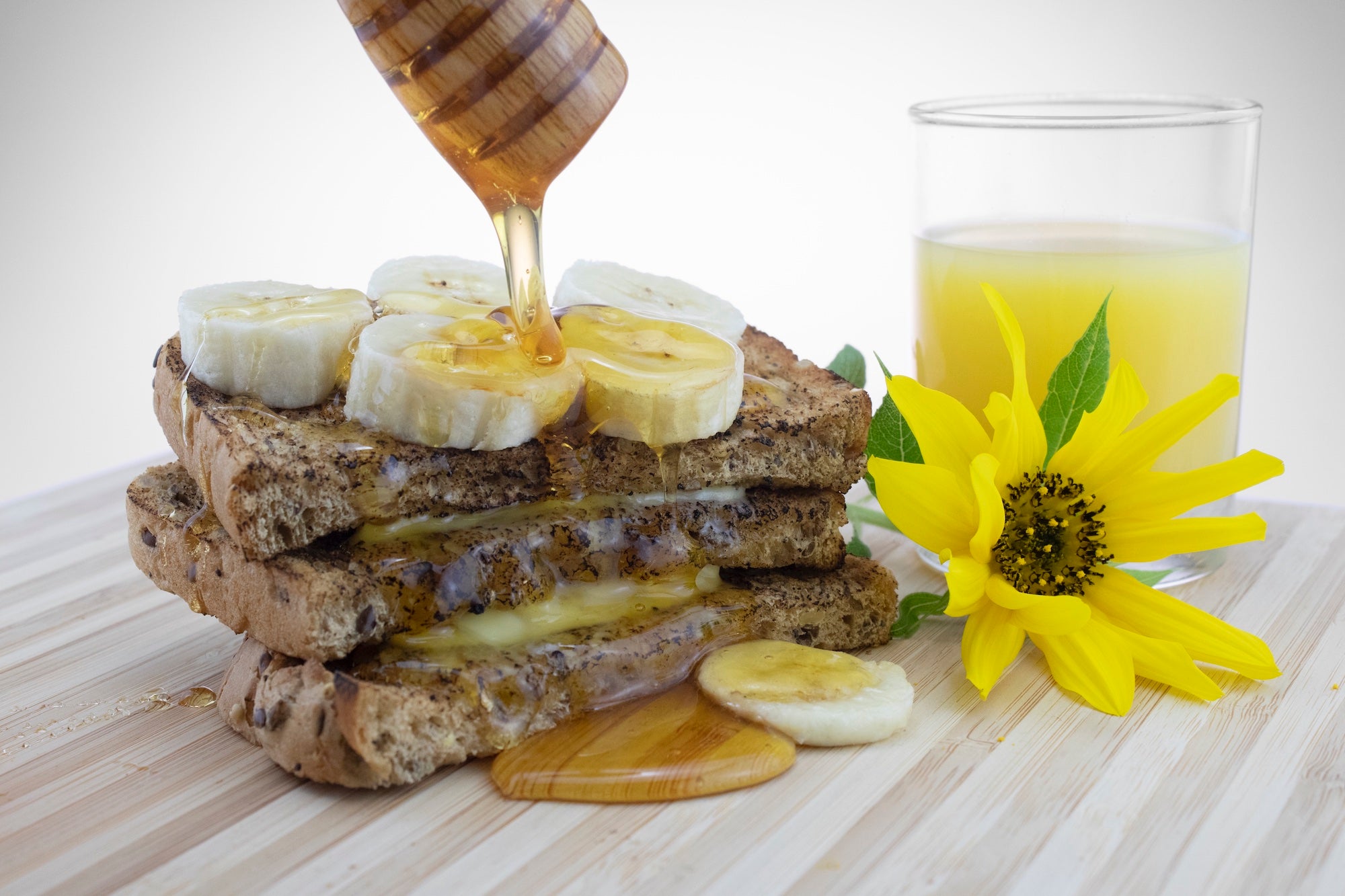Honey on banana sandwich with glass of orange juice
